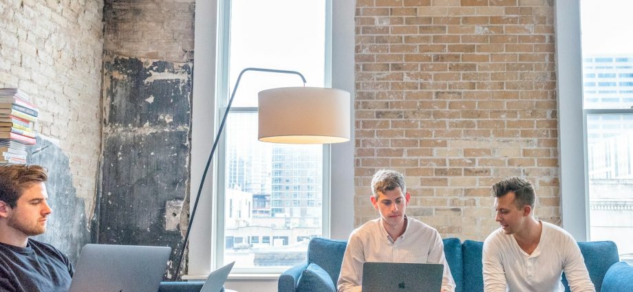 three men using MacBooks